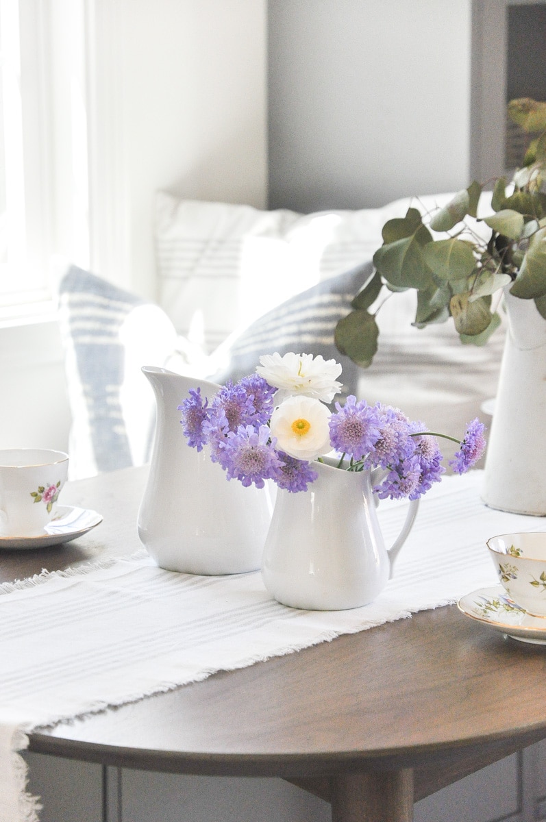 white ceramic pitcher, pincushion flowers, farmhouse dining table