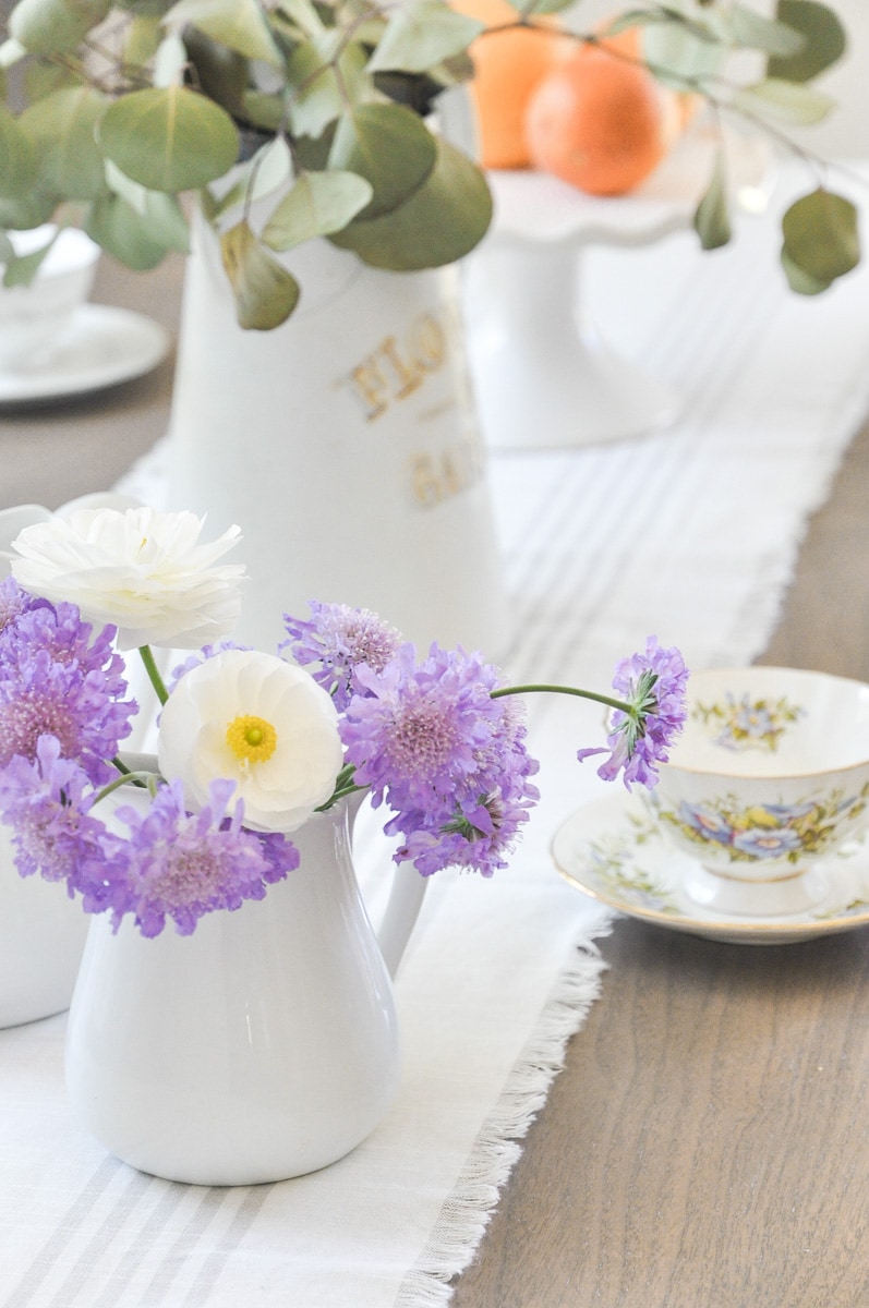 white ceramic pitcher, pincushion flowers, farmhouse dining table