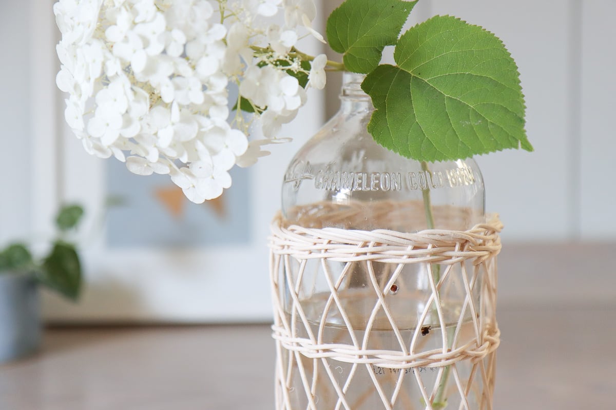 glass bottle craft idea - rattan covered vase 
