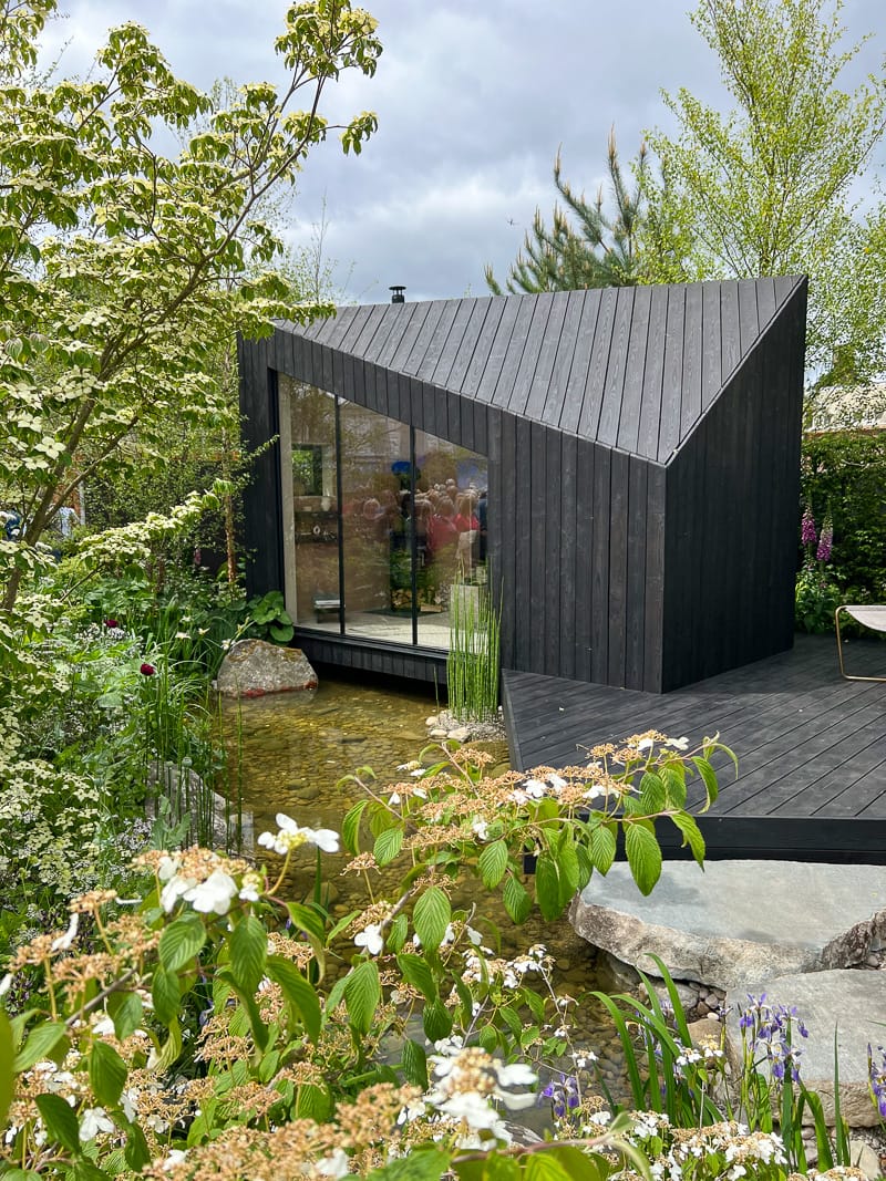 mini cabin house on water, european garden
