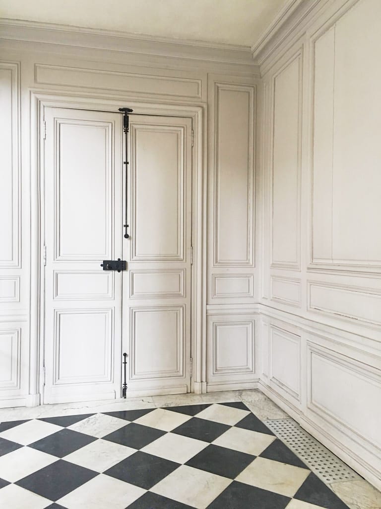 european decorating styles french paneled wall and checkered floor