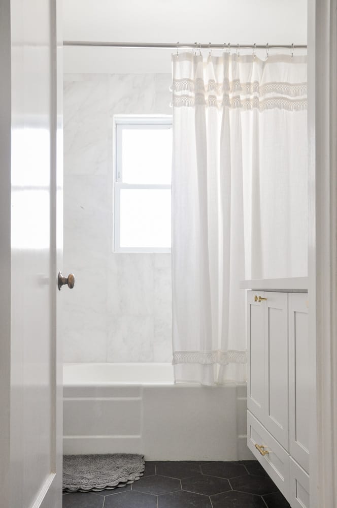 Add extra storage with an extra shower curtain rod, then all you