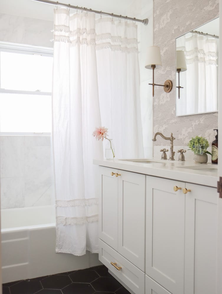 Add extra storage with an extra shower curtain rod, then all you